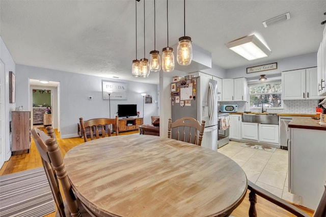 dining area featuring sink and light hardwood / wood-style floors