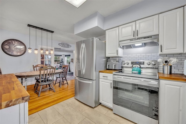 kitchen featuring wood counters, hanging light fixtures, white cabinets, and appliances with stainless steel finishes