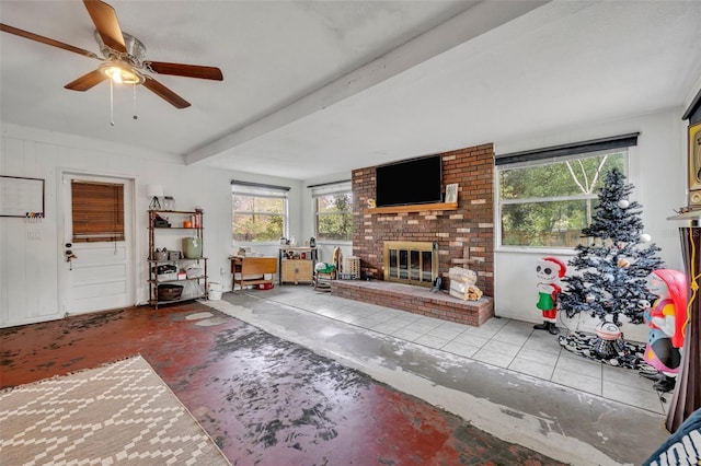 unfurnished living room with ceiling fan, a healthy amount of sunlight, and a brick fireplace