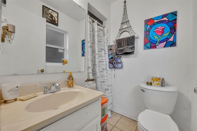 bathroom featuring tile patterned flooring, vanity, and toilet