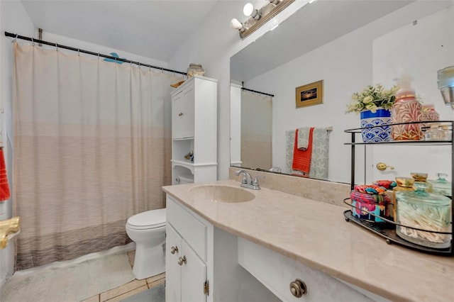 bathroom with vanity, tile patterned flooring, and toilet