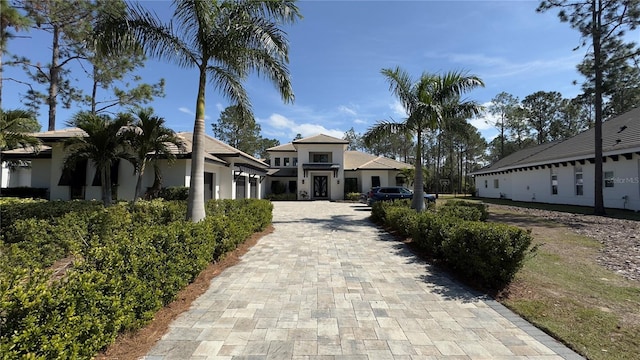 view of front of home with an attached garage and stucco siding