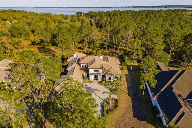 drone / aerial view featuring a water view and a forest view