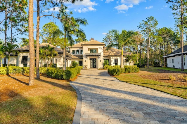 mediterranean / spanish house with a front yard