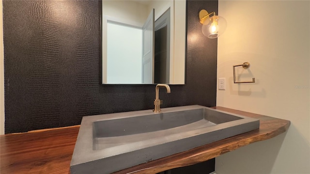 bathroom featuring wood finished floors and a sink