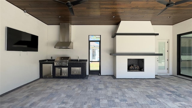 view of patio featuring a fireplace, grilling area, an outdoor kitchen, a ceiling fan, and a sink