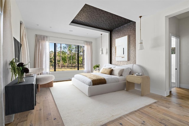 bedroom with baseboards and light wood-style floors