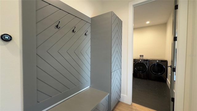 mudroom with separate washer and dryer and light wood-type flooring