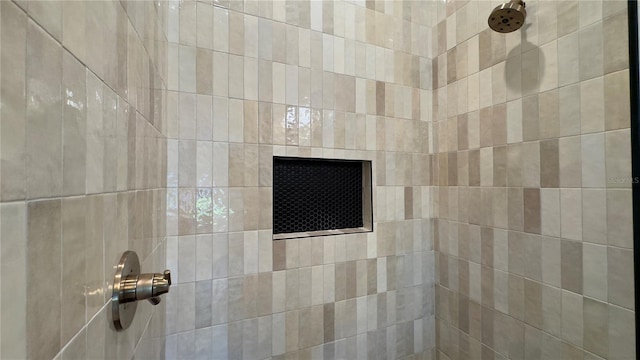 interior details with a tile shower