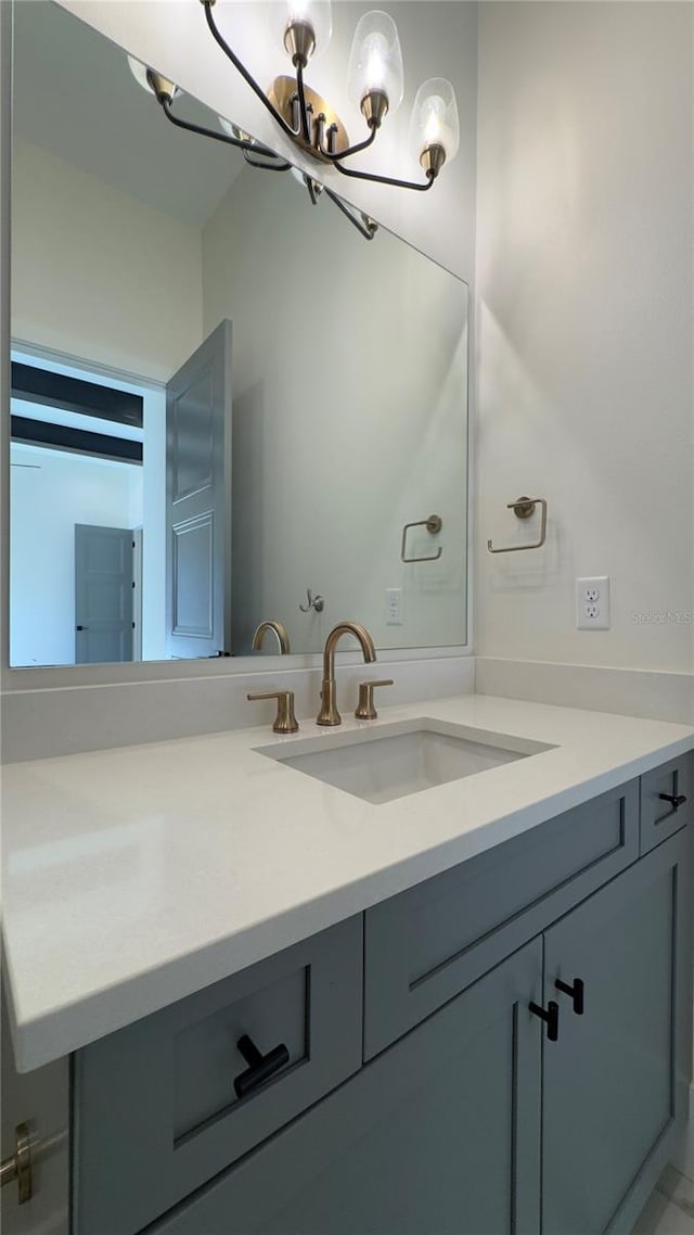 bathroom with vanity and an inviting chandelier