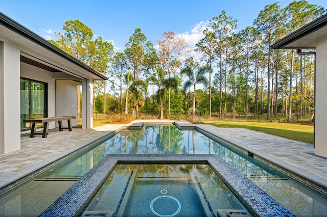 pool with a patio area and a fenced backyard