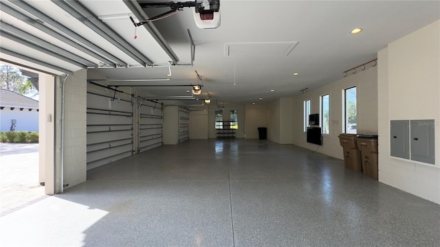 garage with electric panel and a garage door opener