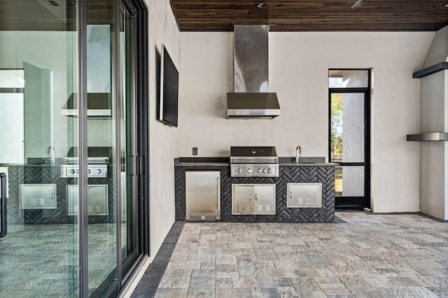 view of patio / terrace with a sink, an outdoor kitchen, and area for grilling