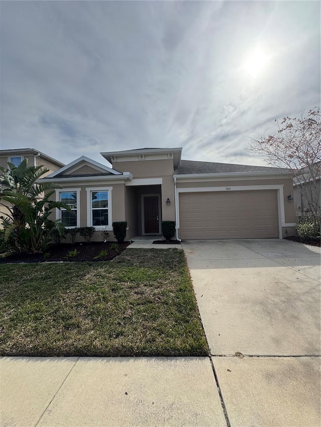 view of front of property with a garage and a front yard