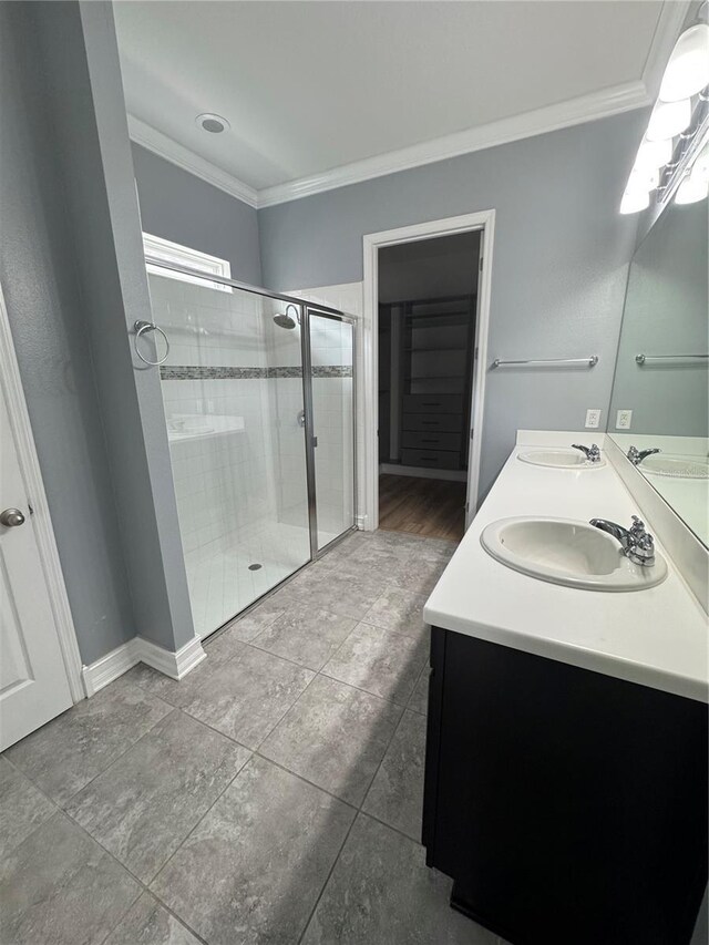 bathroom with vanity, ornamental molding, and walk in shower