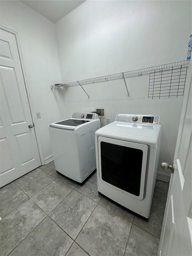 clothes washing area featuring separate washer and dryer