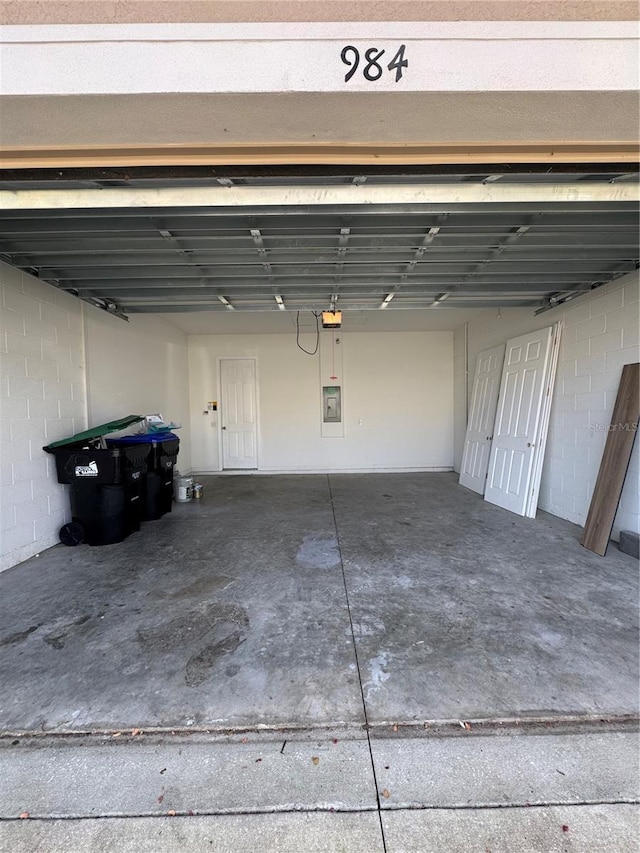 garage featuring a garage door opener and electric panel