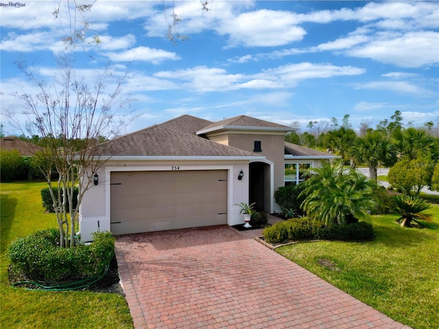 view of front of house featuring a garage and a front lawn