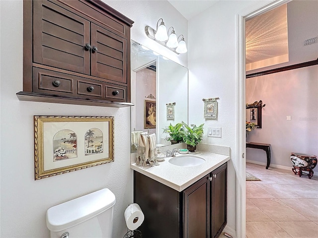 bathroom featuring vanity, tile patterned flooring, and toilet