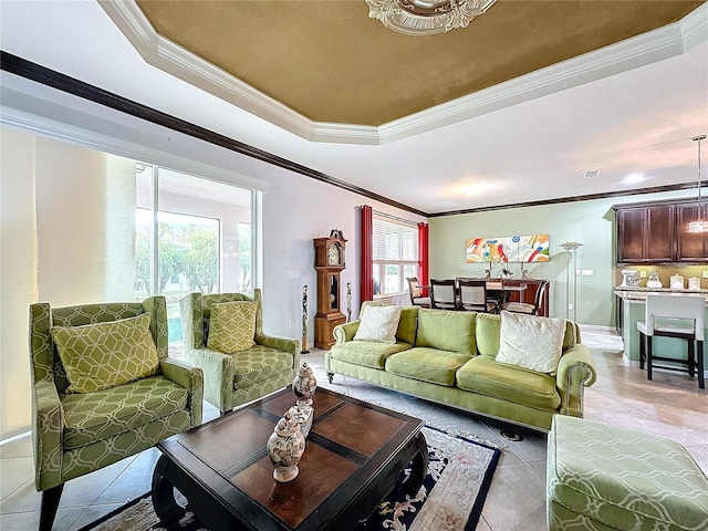 tiled living room featuring crown molding and a raised ceiling