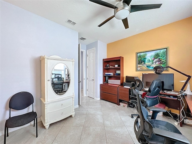 office area with ceiling fan, a textured ceiling, and light tile patterned floors