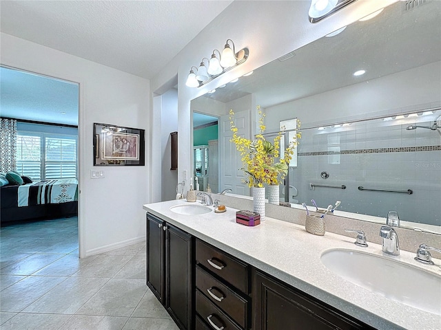 bathroom featuring vanity, tile patterned floors, and a textured ceiling