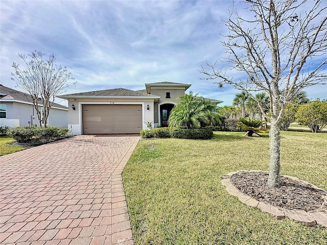 view of front of house featuring a garage and a front lawn