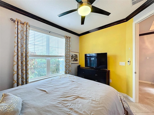 bedroom with ornamental molding, light tile patterned flooring, ceiling fan, and a textured ceiling