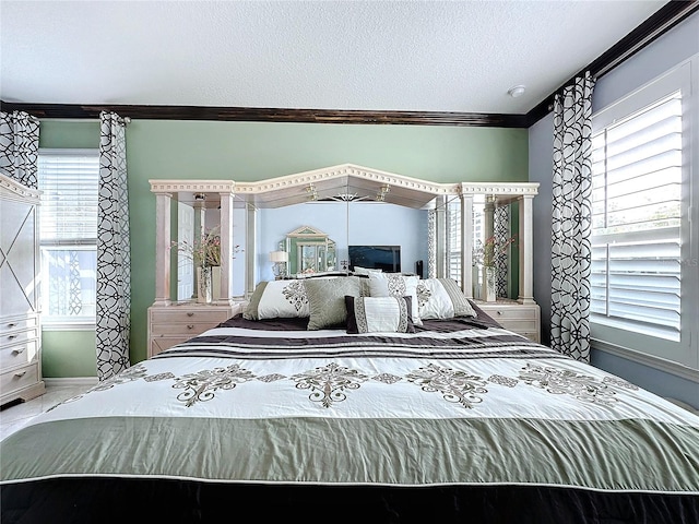 bedroom featuring multiple windows, crown molding, and a textured ceiling