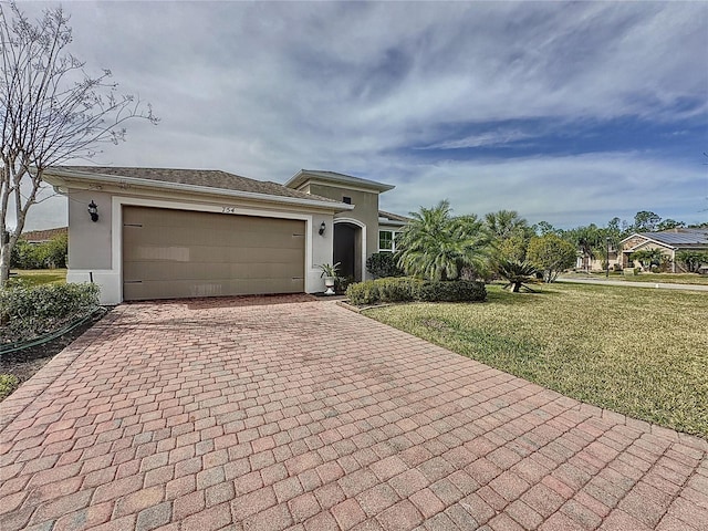 view of front of property featuring a garage and a front yard