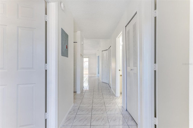 hall with a textured ceiling