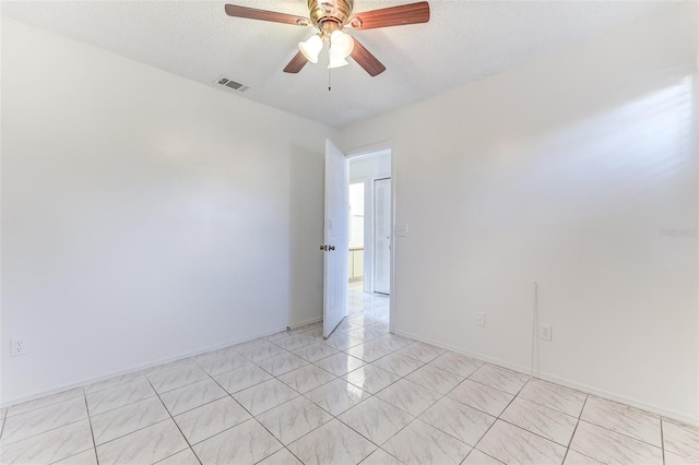 unfurnished room featuring ceiling fan and a textured ceiling