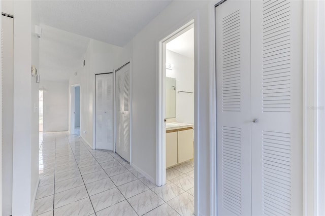 hallway featuring light tile patterned floors