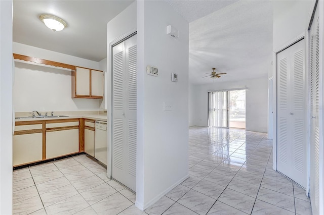 hallway with sink and a textured ceiling