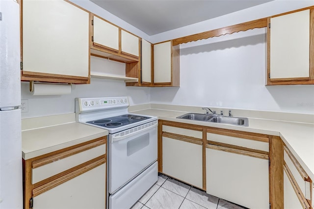 kitchen with sink, white appliances, and white cabinets