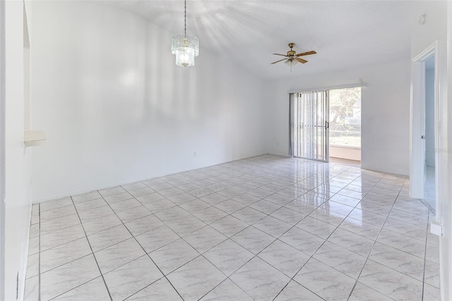 empty room featuring ceiling fan with notable chandelier and vaulted ceiling