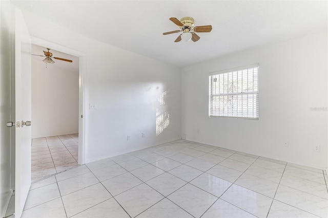 unfurnished room with ceiling fan and light tile patterned flooring