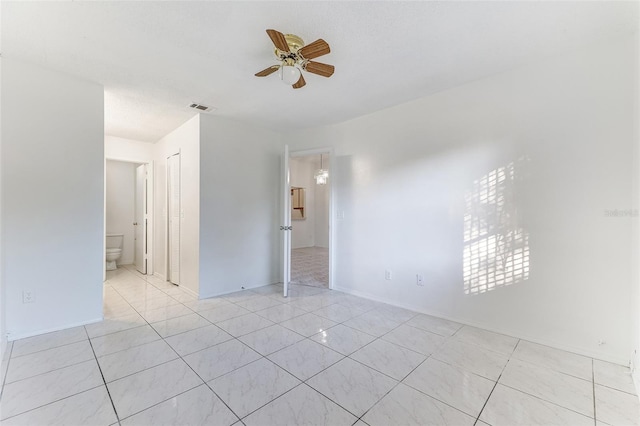 spare room featuring light tile patterned flooring and ceiling fan