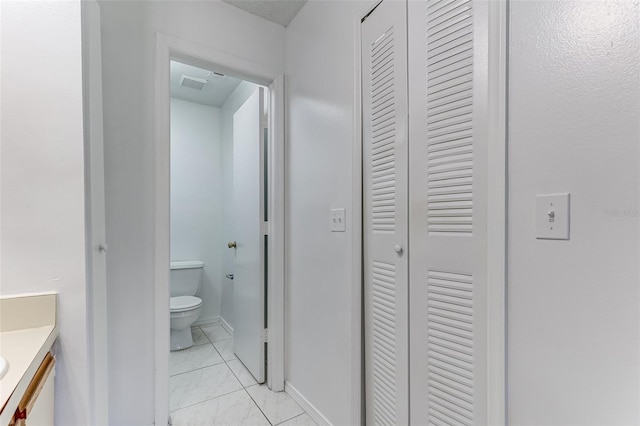 bathroom featuring vanity and toilet