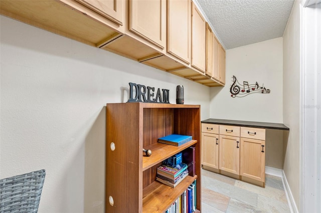 interior details featuring a textured ceiling