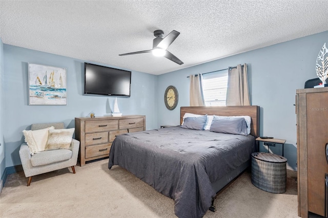 carpeted bedroom with a textured ceiling and ceiling fan