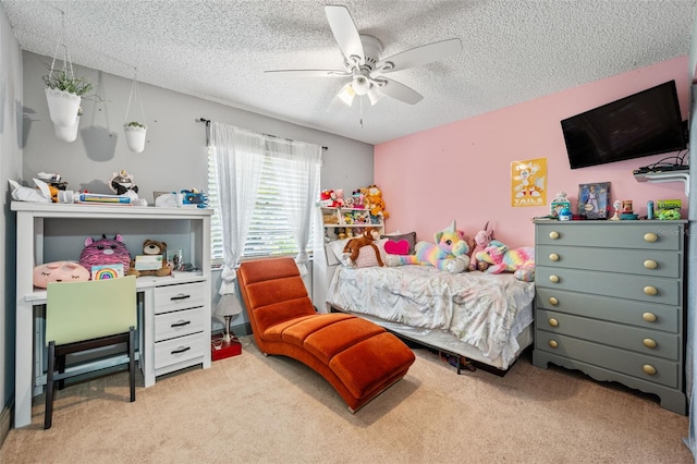 carpeted bedroom featuring ceiling fan and a textured ceiling