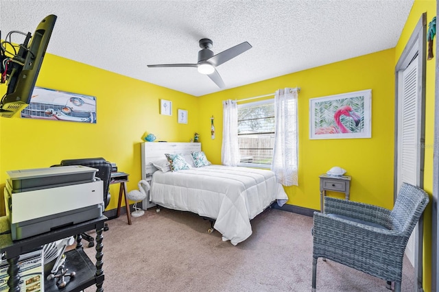 carpeted bedroom with ceiling fan, a closet, and a textured ceiling