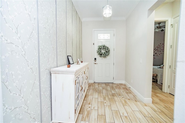 foyer with ornamental molding and light wood-type flooring