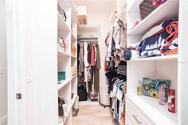 spacious closet with light hardwood / wood-style floors