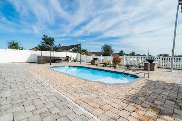 view of swimming pool featuring a patio area