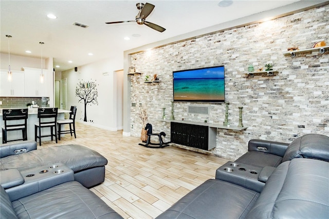 living room featuring ceiling fan and light hardwood / wood-style flooring