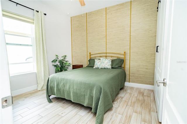 bedroom with ceiling fan and wood-type flooring