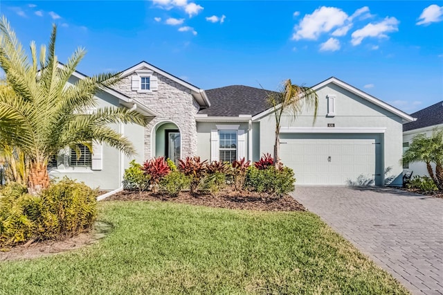 view of front of home with a garage and a front yard