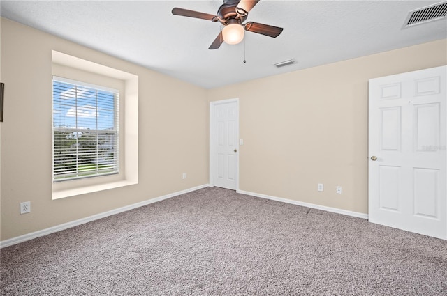 carpeted empty room with a textured ceiling and ceiling fan